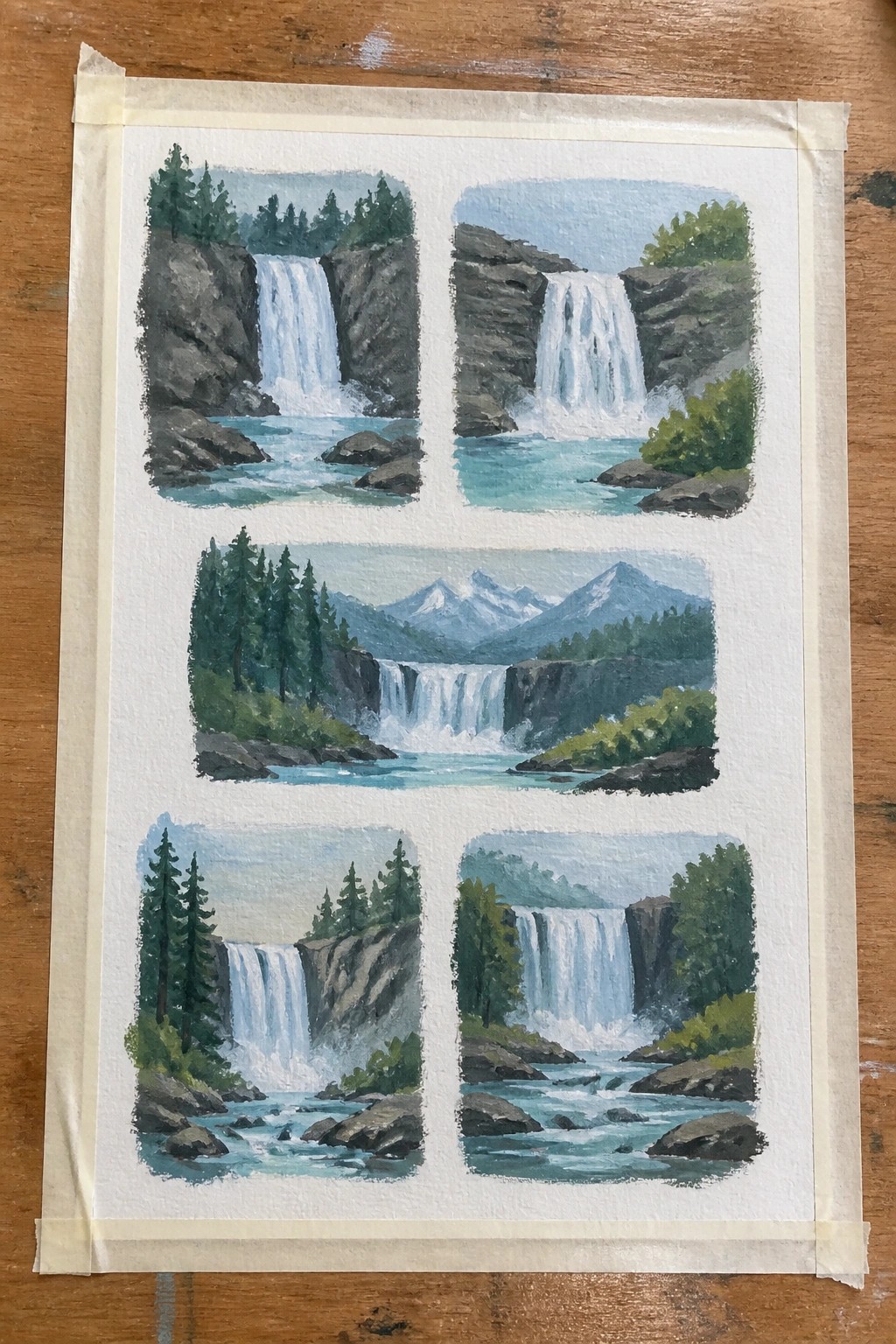 Five watercolor paintings of waterfalls with trees and rocks taped on wood.