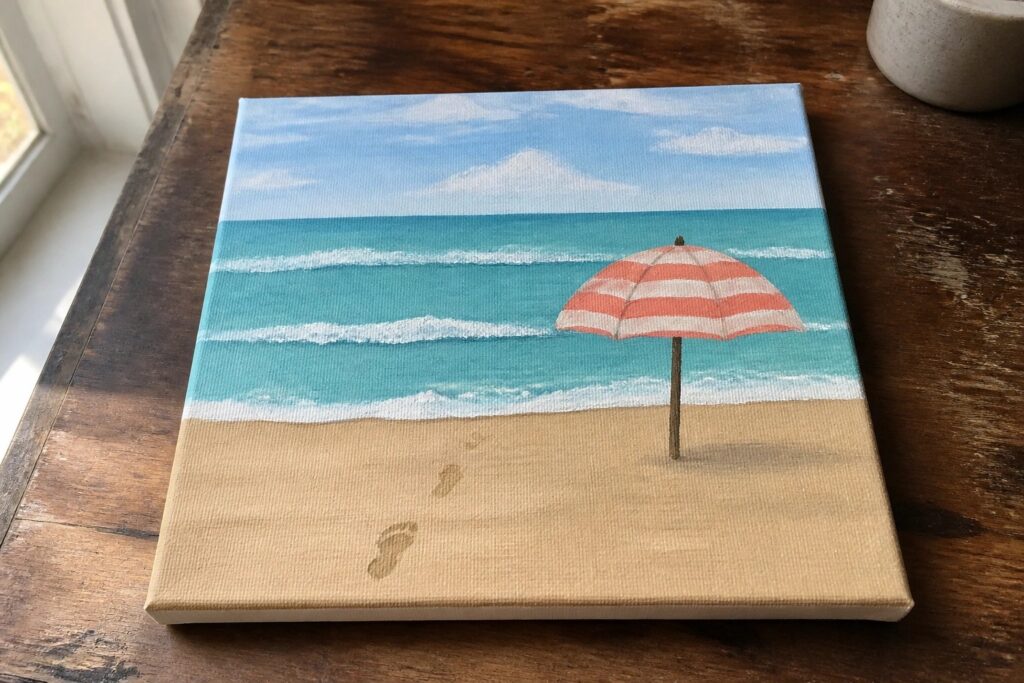 20 Beach Acrylic Painting Ideas For A Refreshing Coastal Feel Beach painting with red-striped umbrella on sand, turquoise waves, and footprints