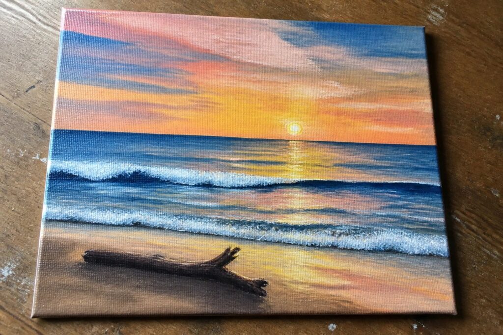 20 Beautiful Landscape Acrylic Painting Ideas For A Peaceful Escape Vibrant sunset over ocean with colorful sky, waves, and driftwood on sandy beach