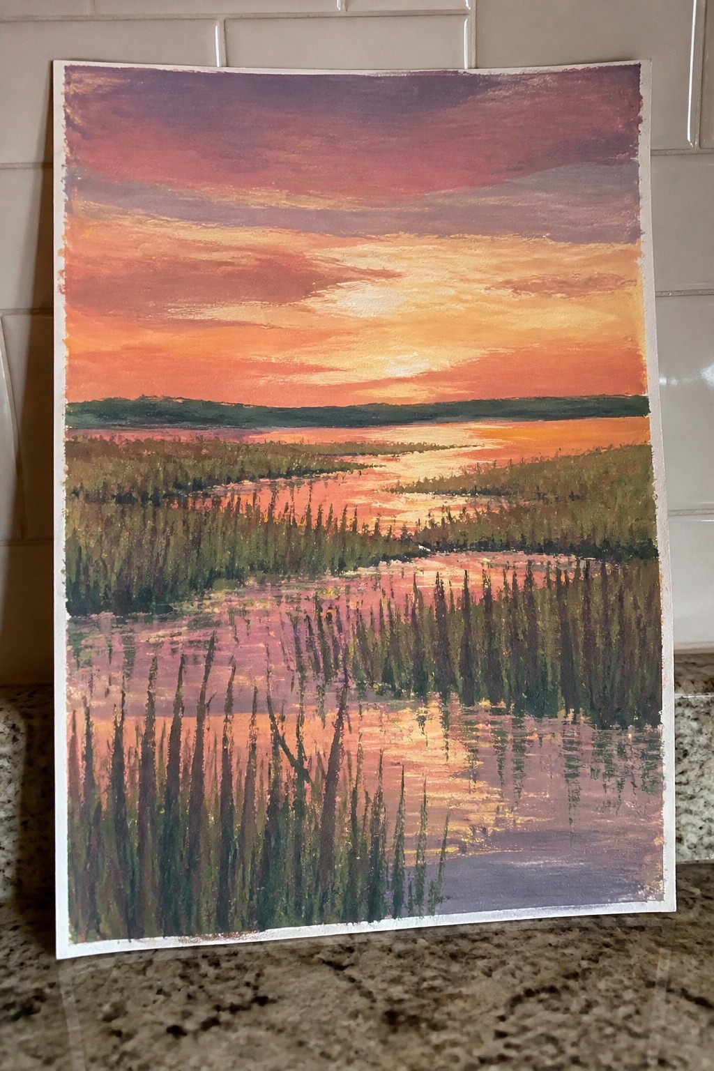 Vivid sunset painting with orange-purple sky reflecting over marsh reeds and distant hills.