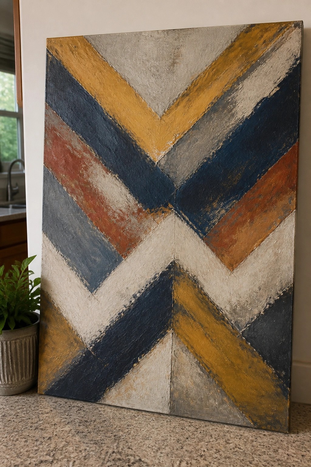 Textured abstract canvas with chevron stripes in navy, mustard, rust, and gray