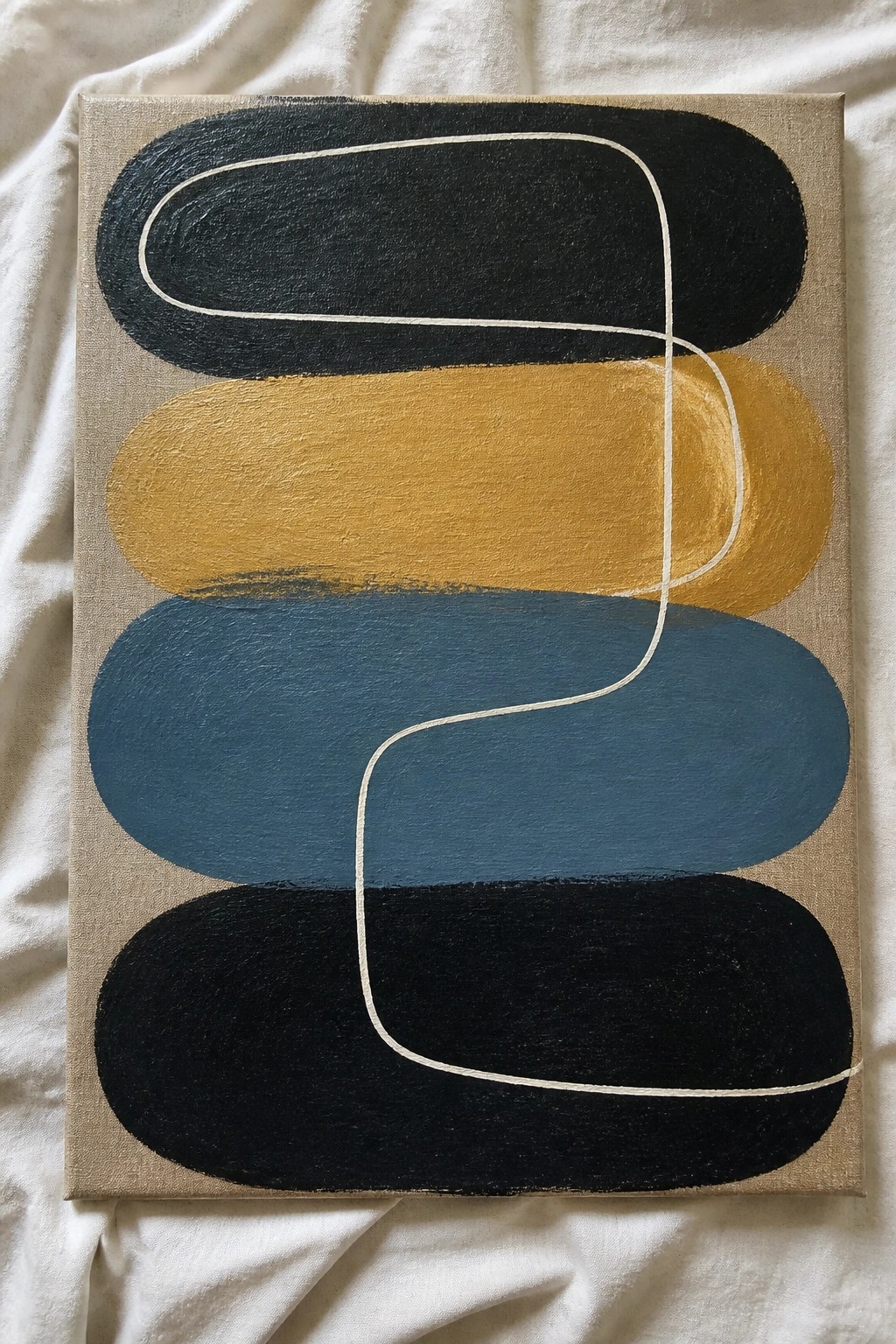 Abstract painting with black, yellow, blue ovals and white curve on beige canvas