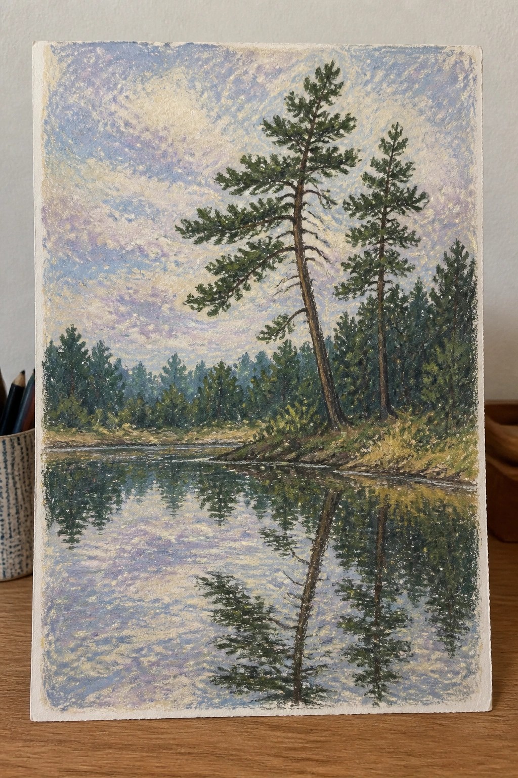 Painting of tall pines reflected in calm river under soft colorful sky.