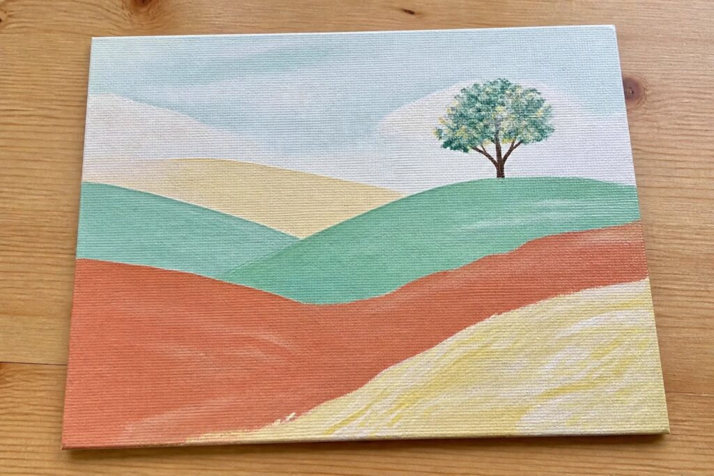 Landscape painting of rolling hills in orange teal yellow green with lone tree and soft sky.