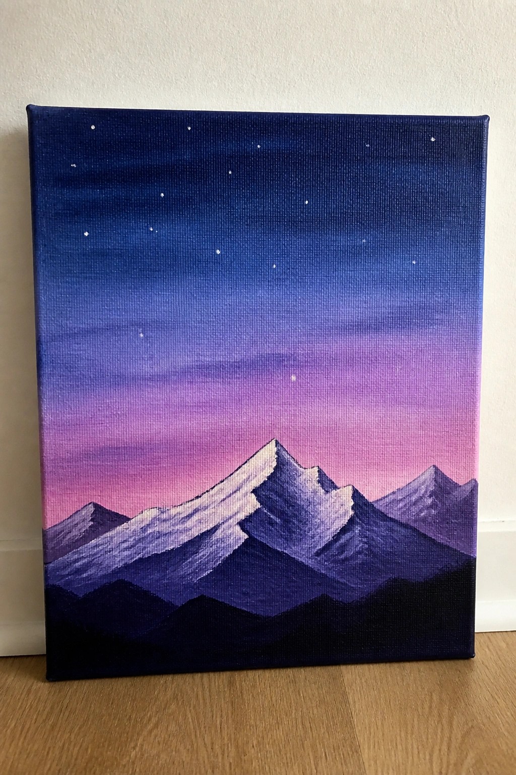 Painting of layered purple mountains with white peaks under a starry gradient sky.