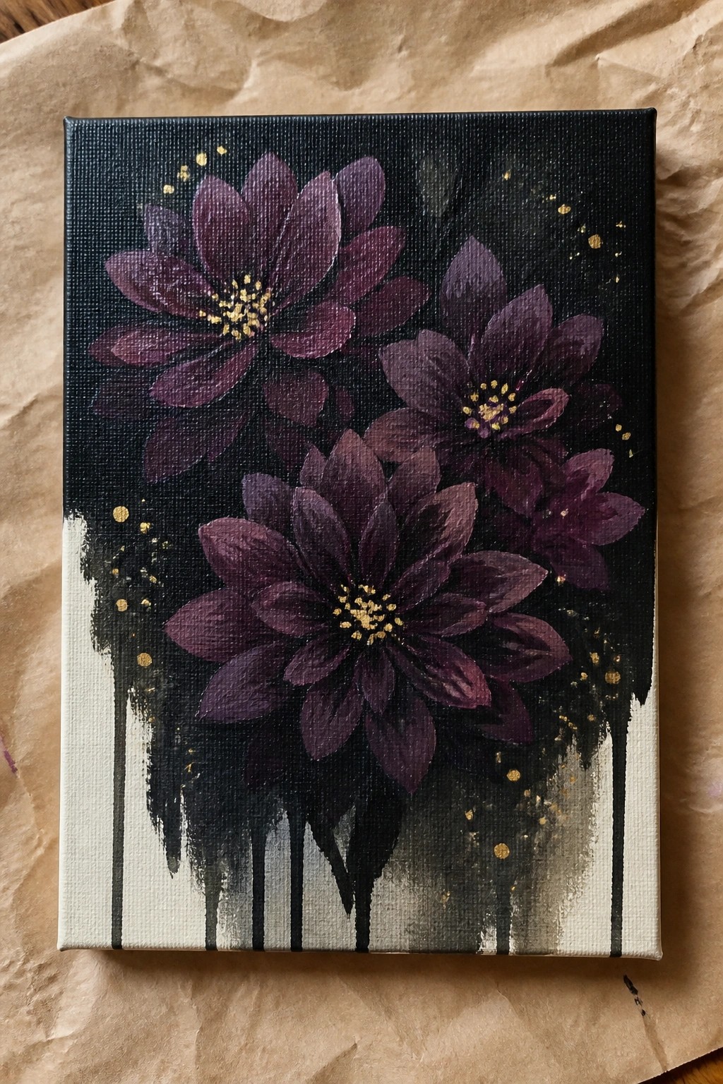 Three dark purple flowers with gold centers on black canvas with drips and splatters