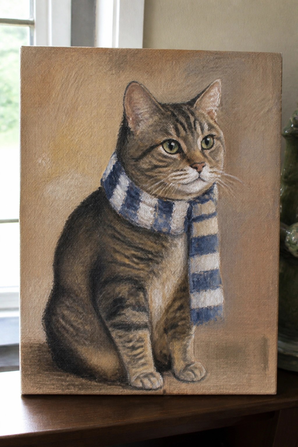 Tabby cat wearing blue and white striped scarf, oil painting on canvas