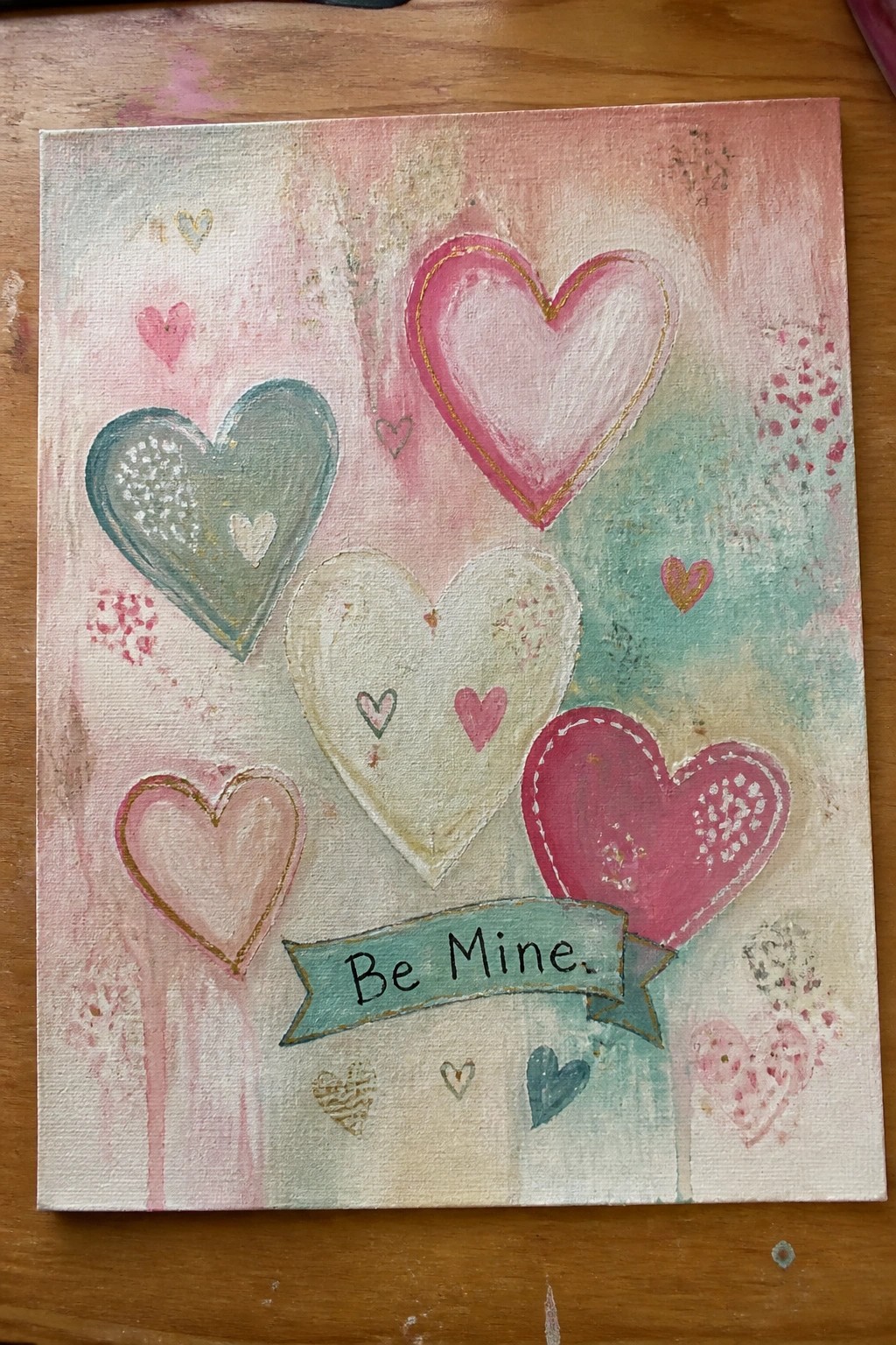 Colorful hearts painting with pink, teal, and gold accents and