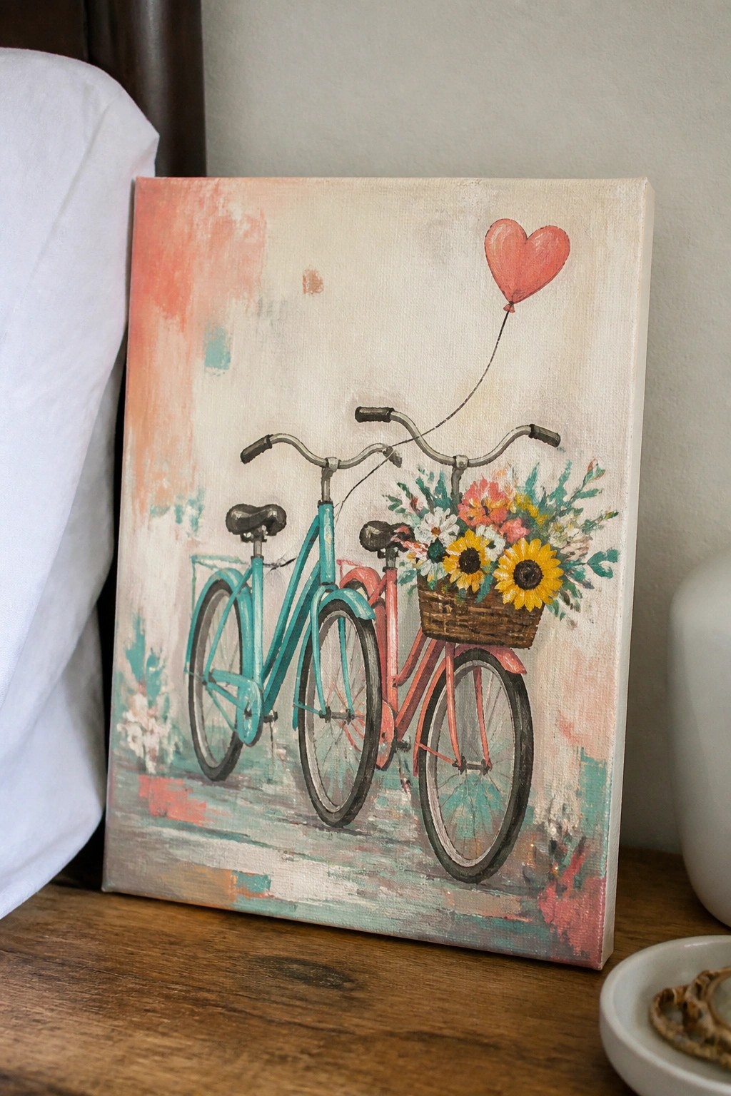Canvas painting of teal and pink bicycles with flower basket and red heart balloon