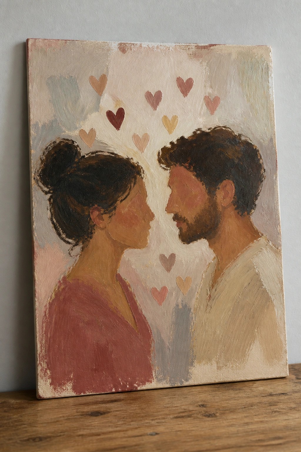 Oil painting of couple in profile with floating colorful hearts between them