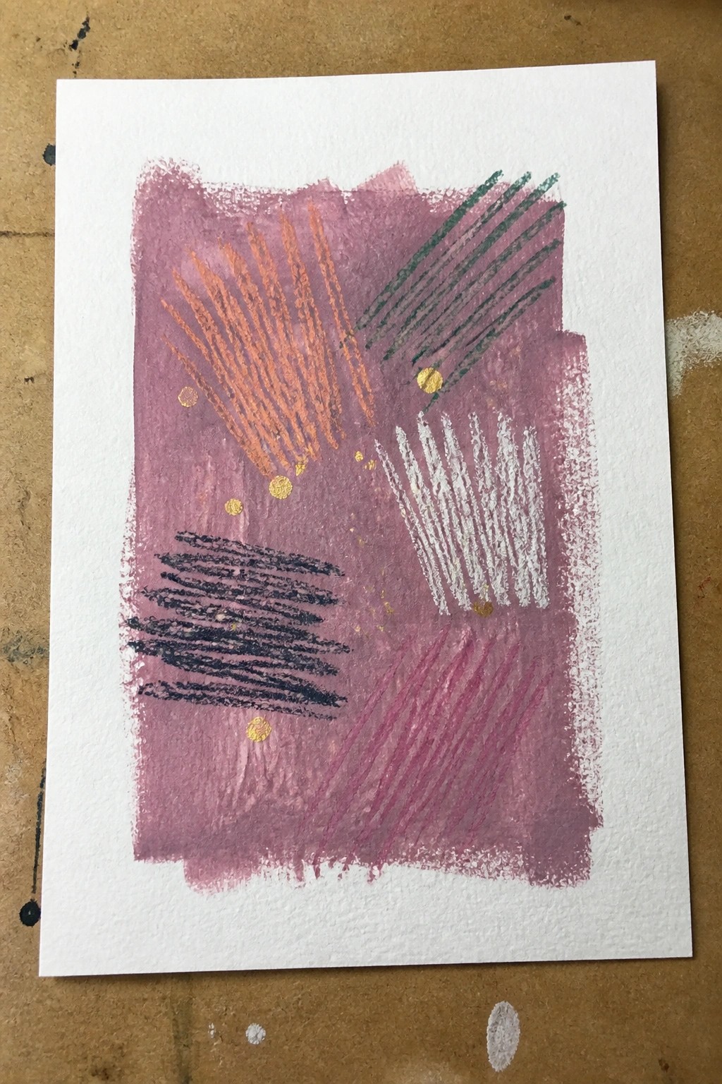 Abstract pink artwork with orange, green, white strokes, black marks, and gold dots.