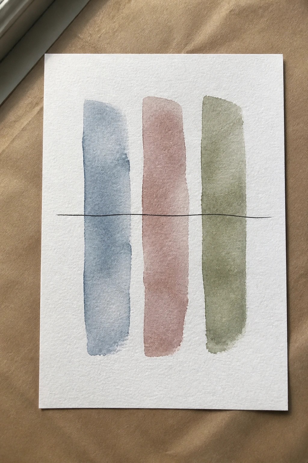 Three vertical watercolor strokes in blue, rose, and green crossed by a black line.