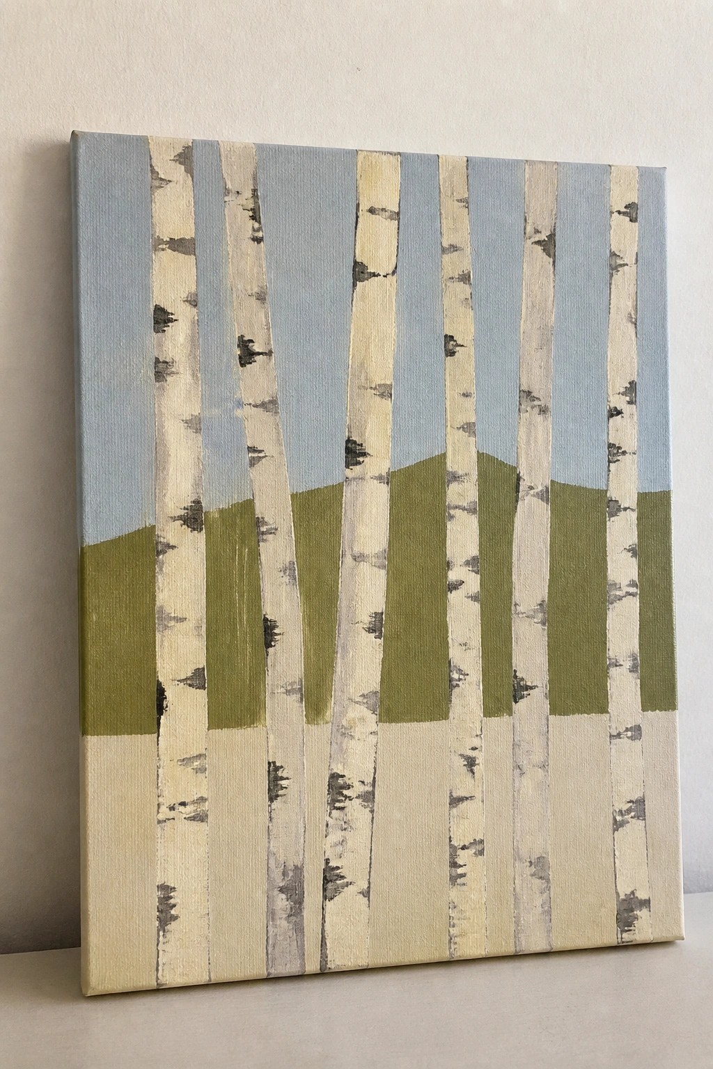 Birch tree painting on canvas with white trunks, blue sky, and green hills