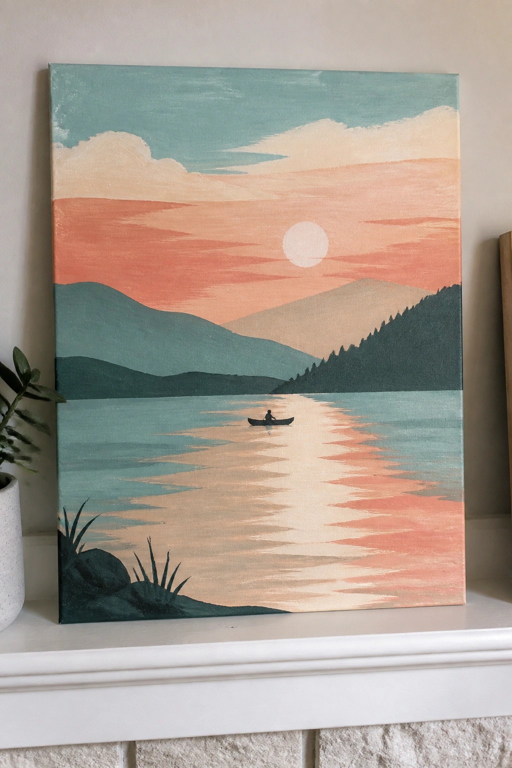 Painting of canoe on reflective lake with mountains under vibrant sunset sky.