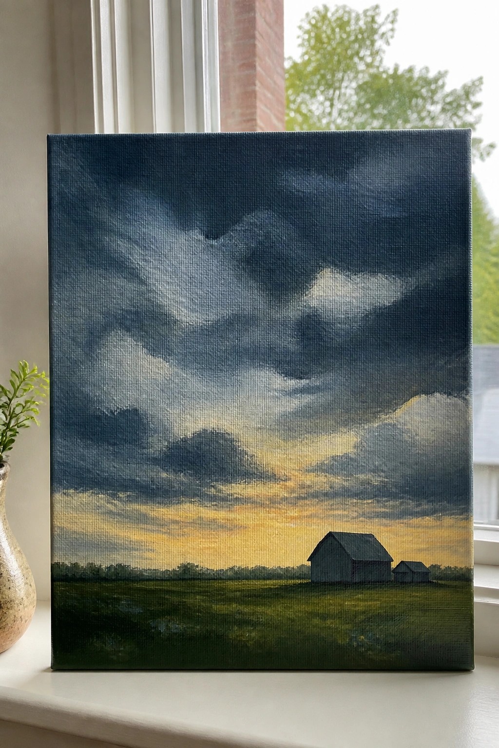Oil painting of dark stormy clouds over green field with barns under golden sunset.