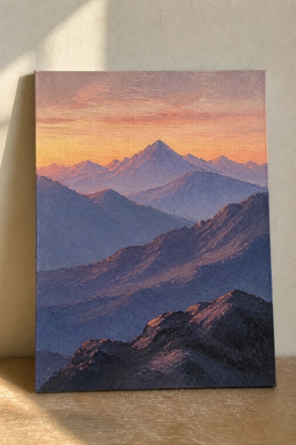 Layered purple mountains under glowing orange-pink sunset sky on canvas.
