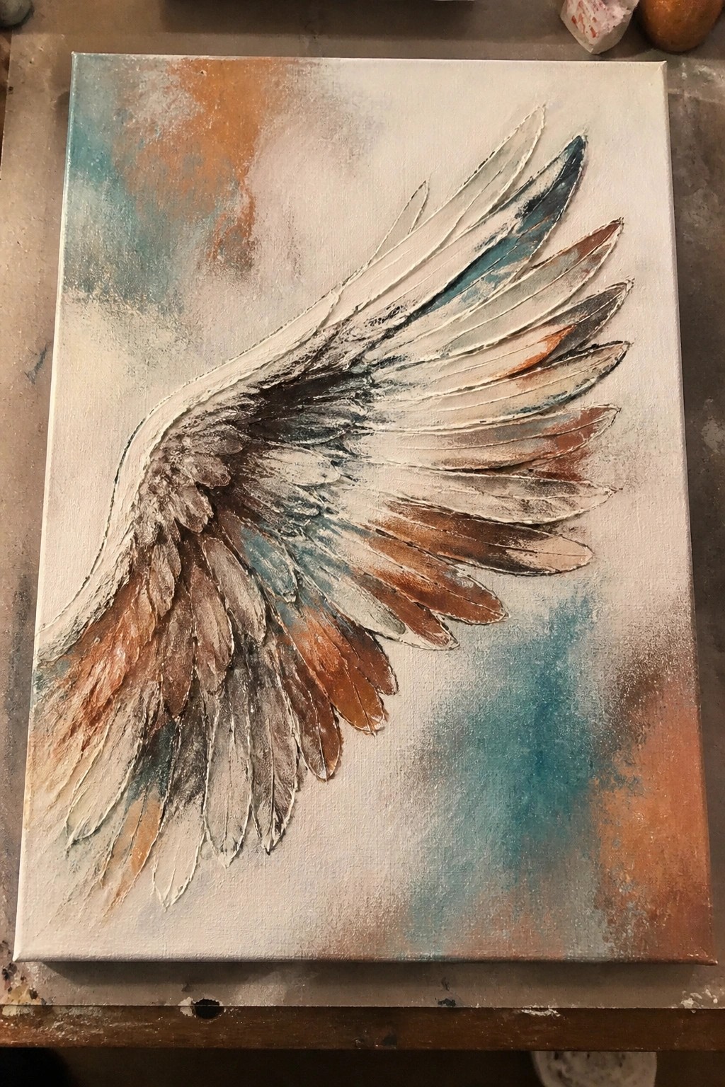 Textured impasto painting of a large wing in brown, teal, and white tones
