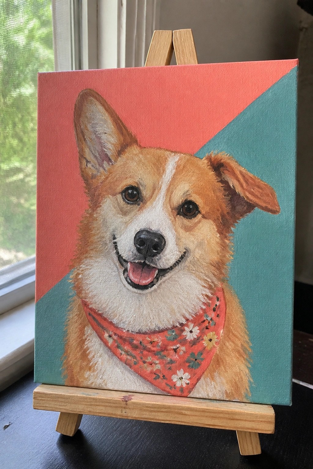 Painting of corgi with floral bandana on easel against split red and teal background