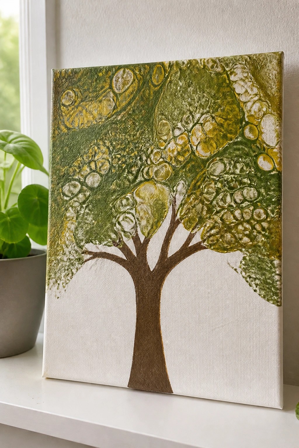 Canvas painting of tree with brown trunk and bubbly green-yellow foliage