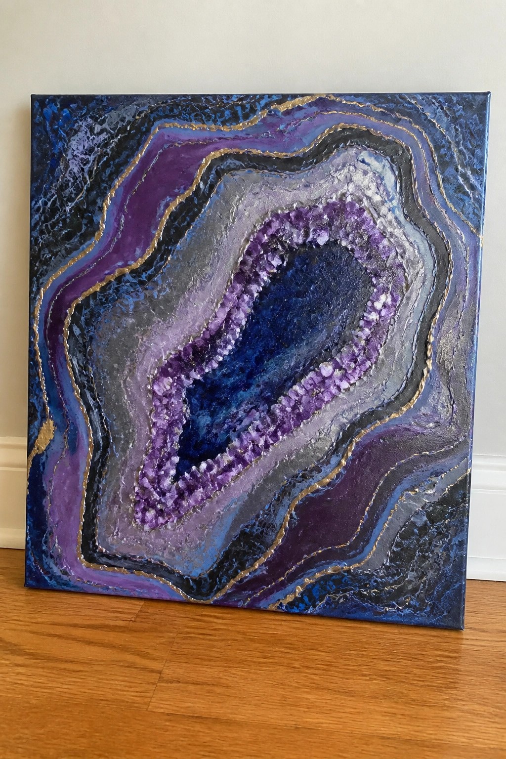 Abstract geode painting with purple crystals, swirling blue-purple layers, and gold accents.