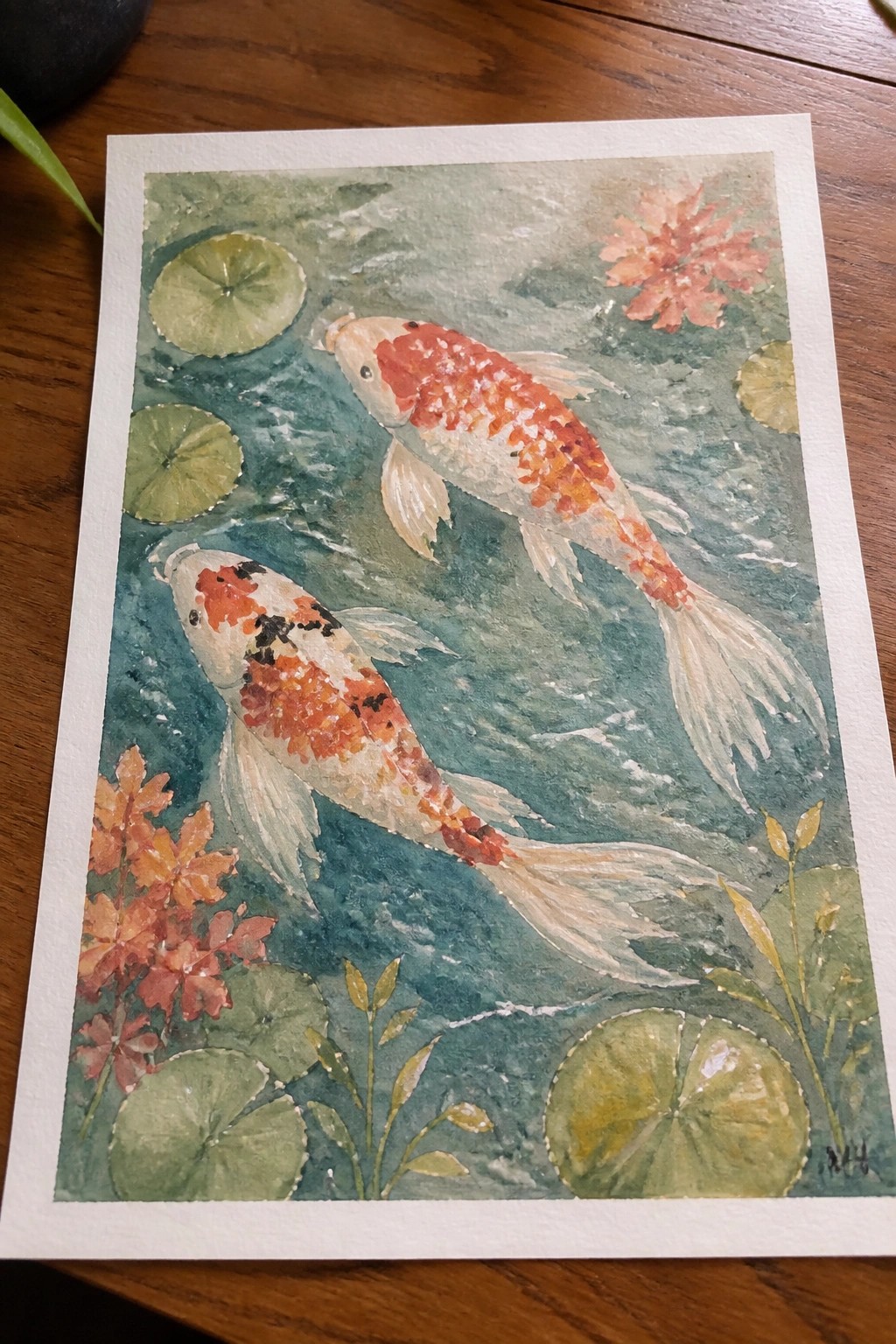 Watercolor painting of two koi fish swimming among lily pads and flowers.