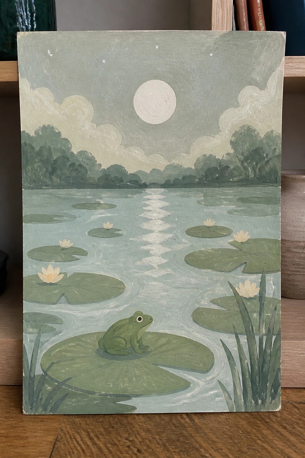 Green frog on lily pad in moonlit pond with white water lilies and clouds