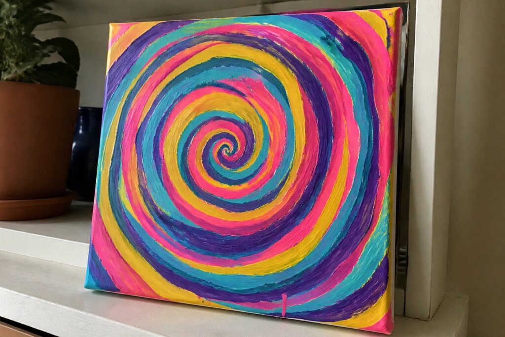 21 Bold Trippy Canvas Painting Ideas for Psychedelic Wall Displays Vibrant multicolored spiral painting on canvas with dripping pink paint at bottom