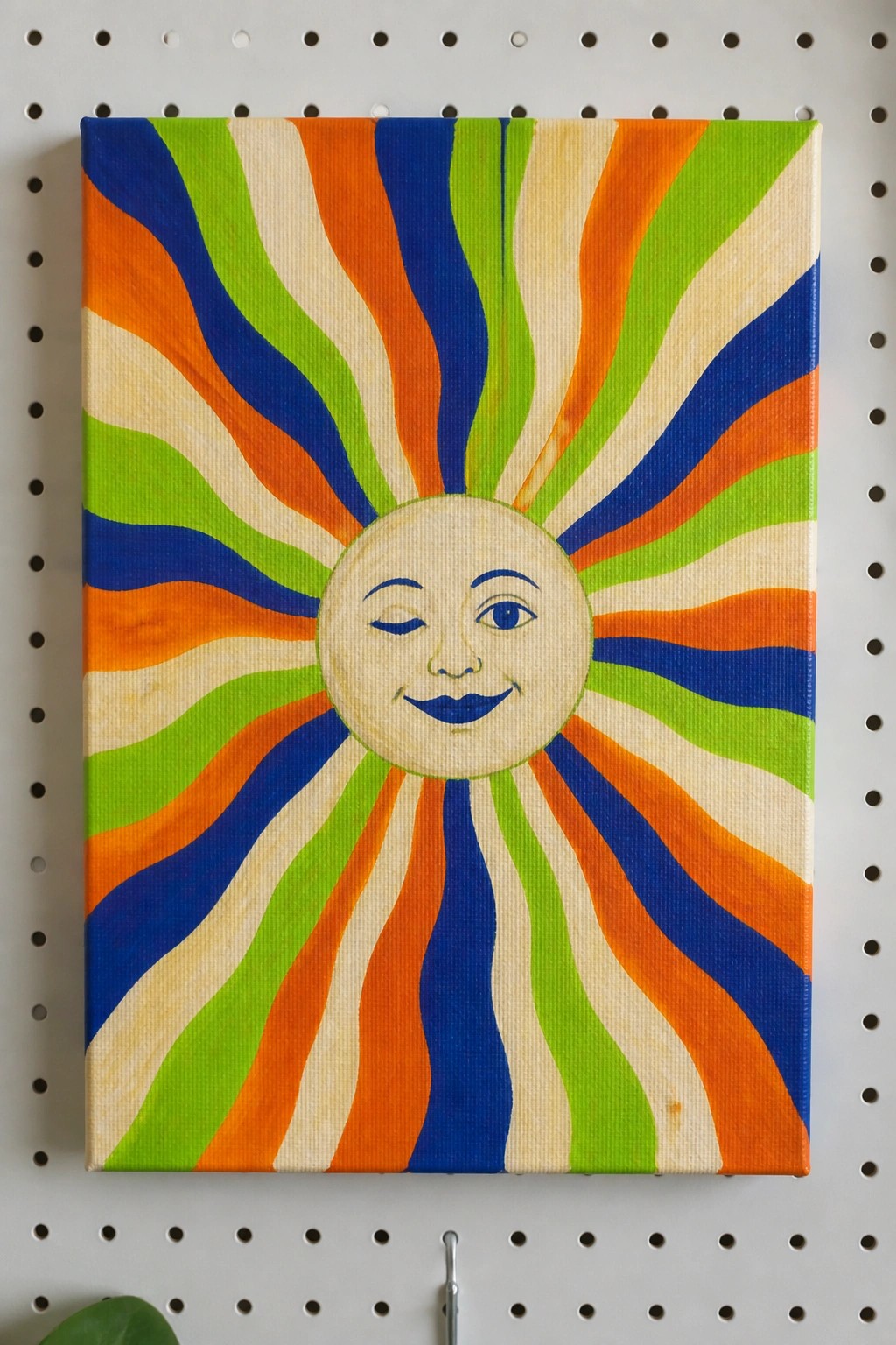 Vibrant sun painting with smiling face and colorful wavy rays on canvas