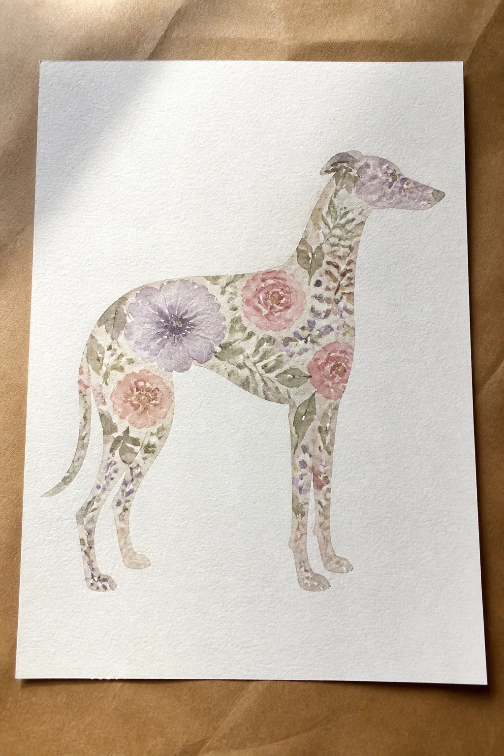 Watercolor greyhound silhouette filled with soft pink, purple, and green florals.