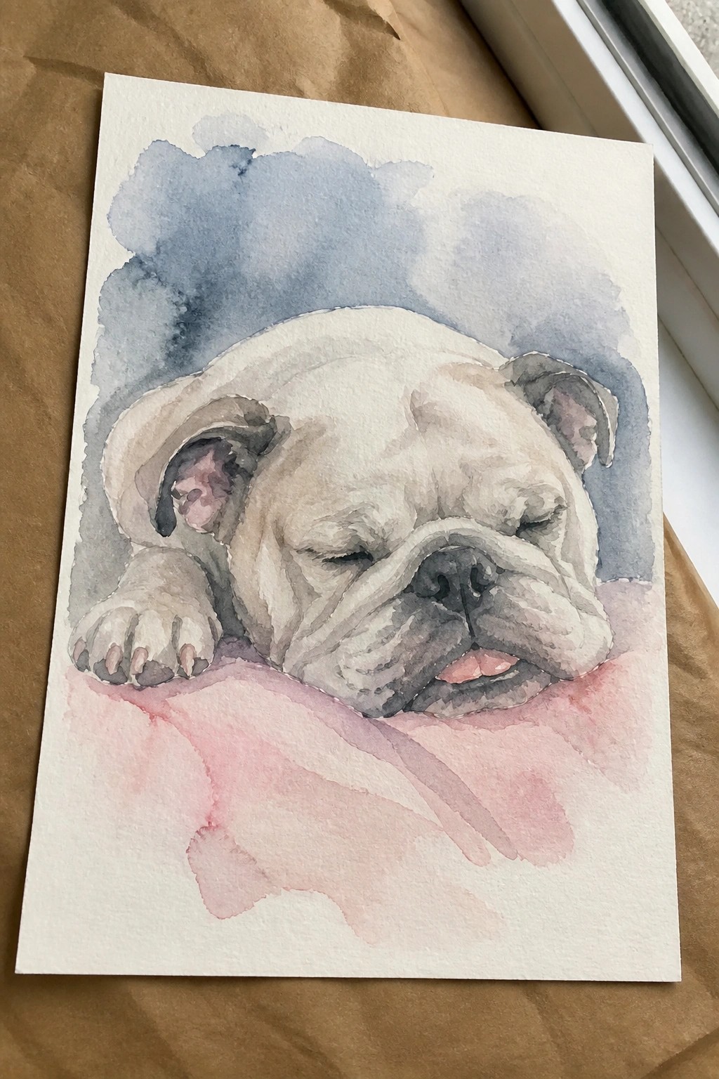 Watercolor of a sleeping white bulldog resting on pink fabric with blue washes behind.