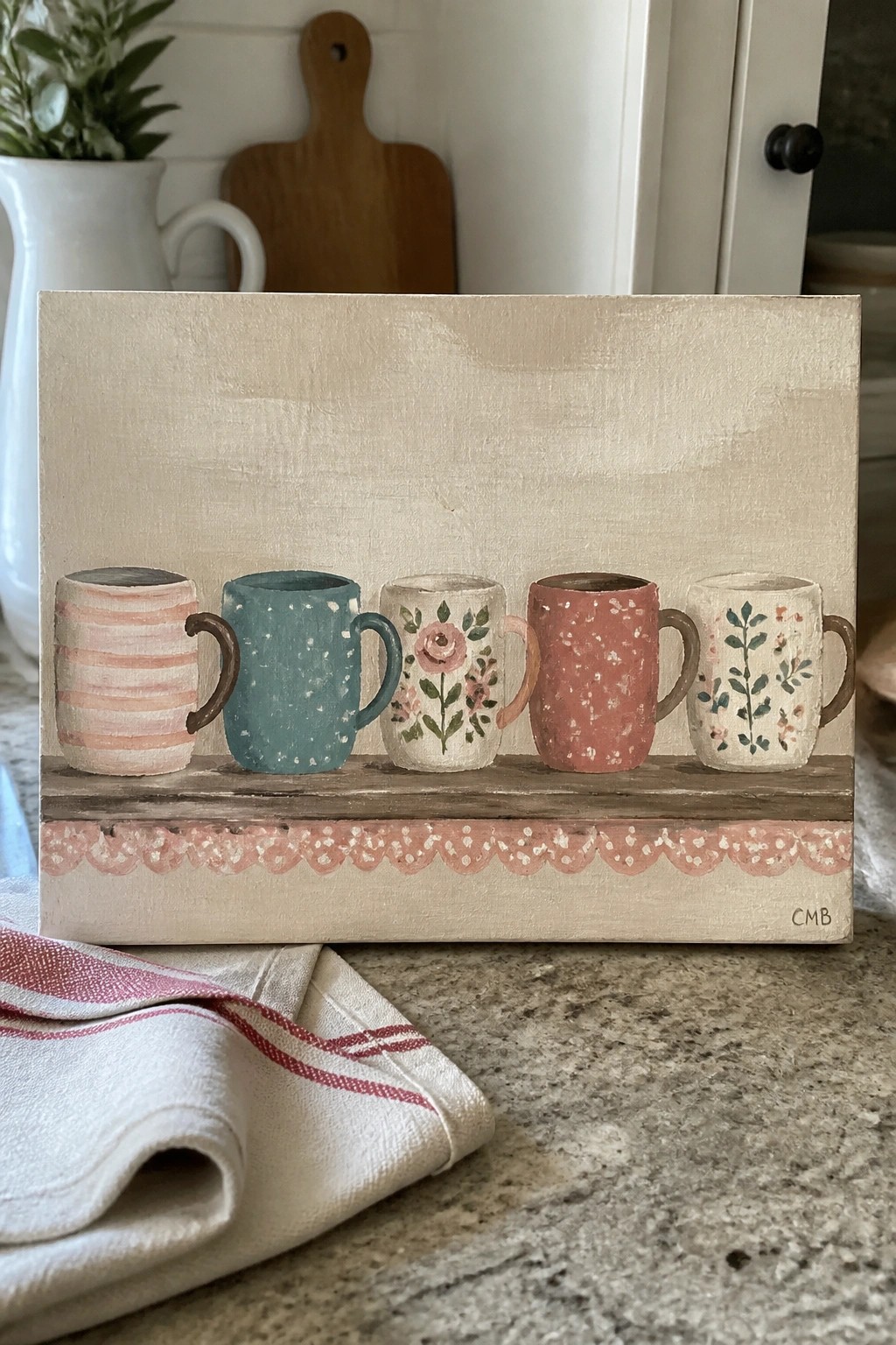 Five colorful patterned mugs on wooden shelf with pink scalloped border