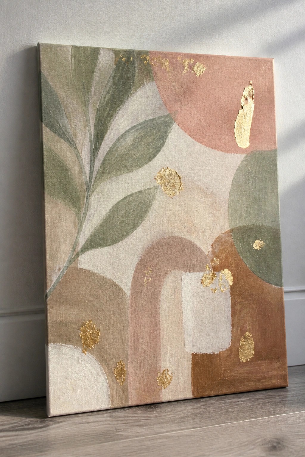 Abstract painting with green leaves, arches, circles, and gold foil in soft earth tones.