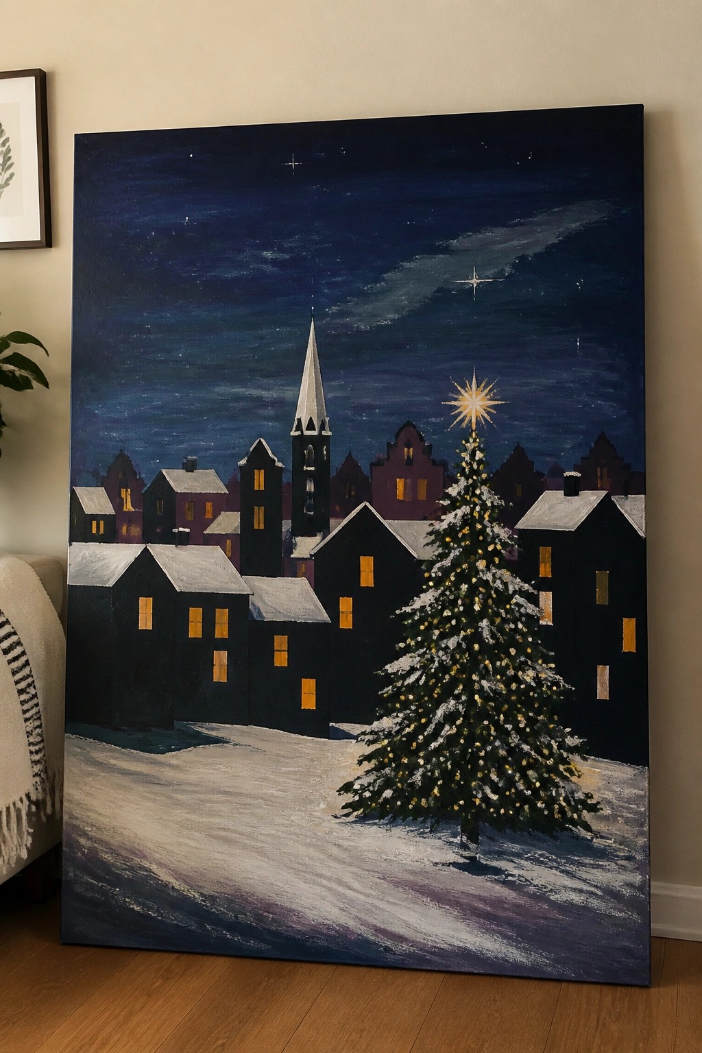 Snowy village at night with glowing windows, Christmas tree, and church steeple under stars