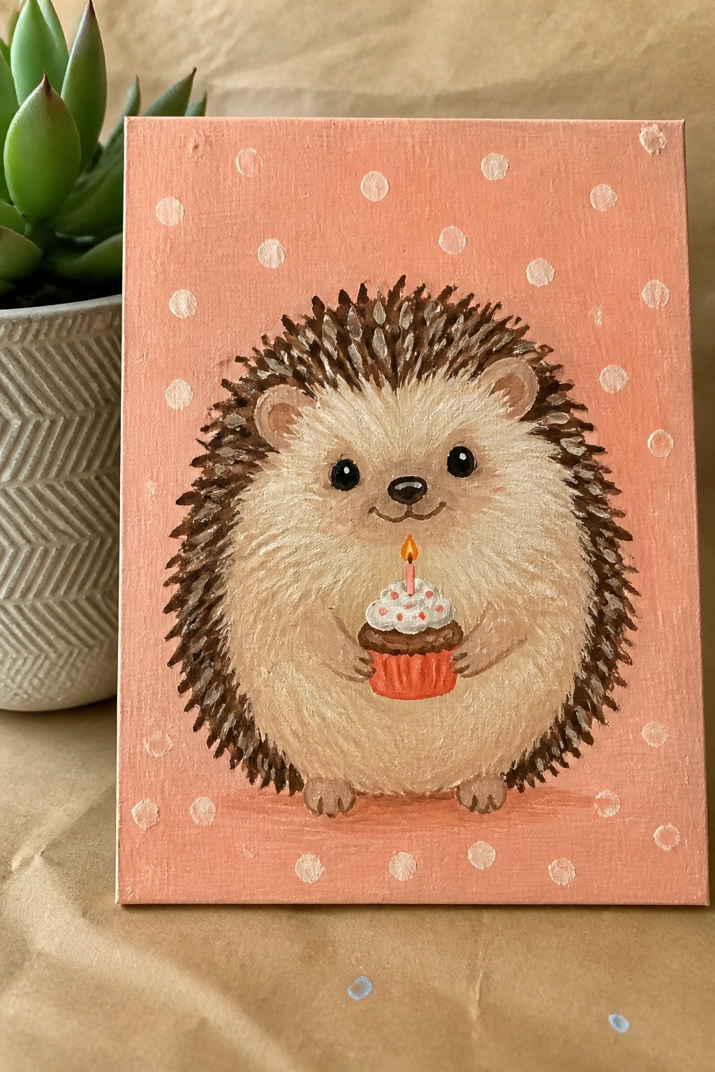 Cute hedgehog holding lit candle cupcake on pink polka dot canvas painting.