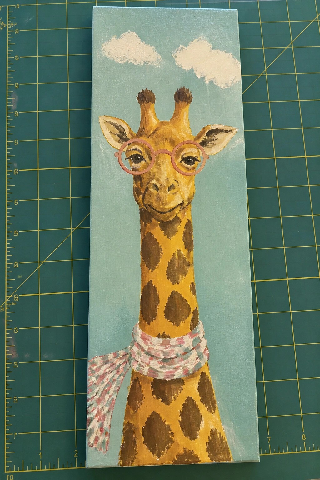 Acrylic painting of giraffe in pink glasses and plaid scarf on blue sky with clouds