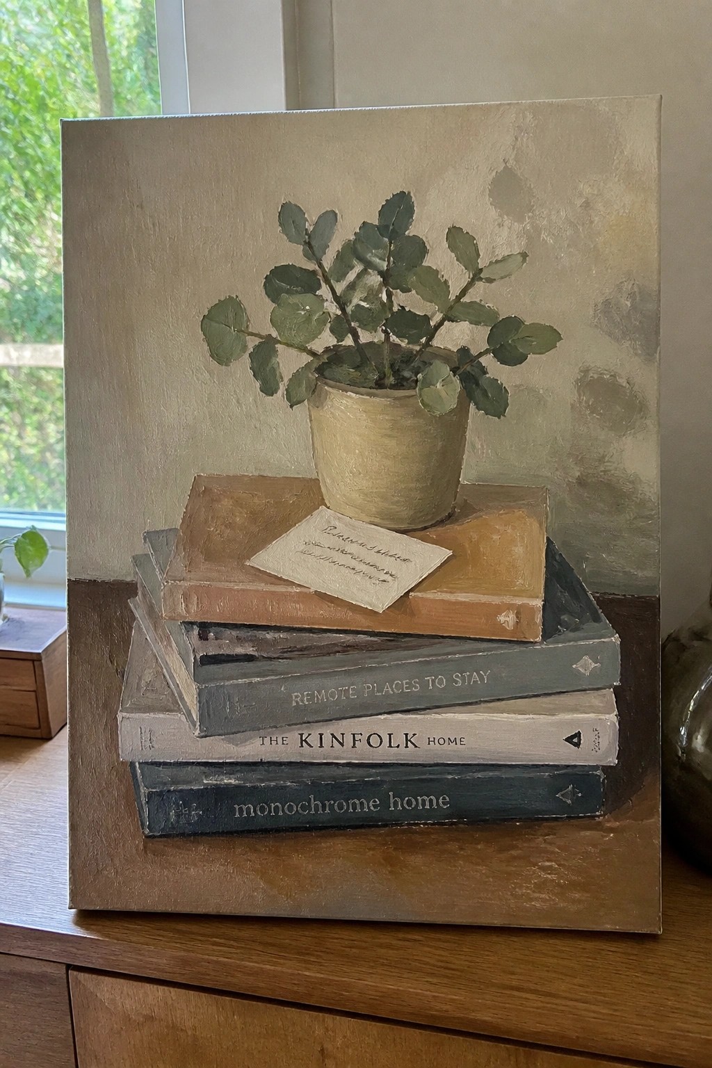Still life painting of potted plant on stack of books with note.