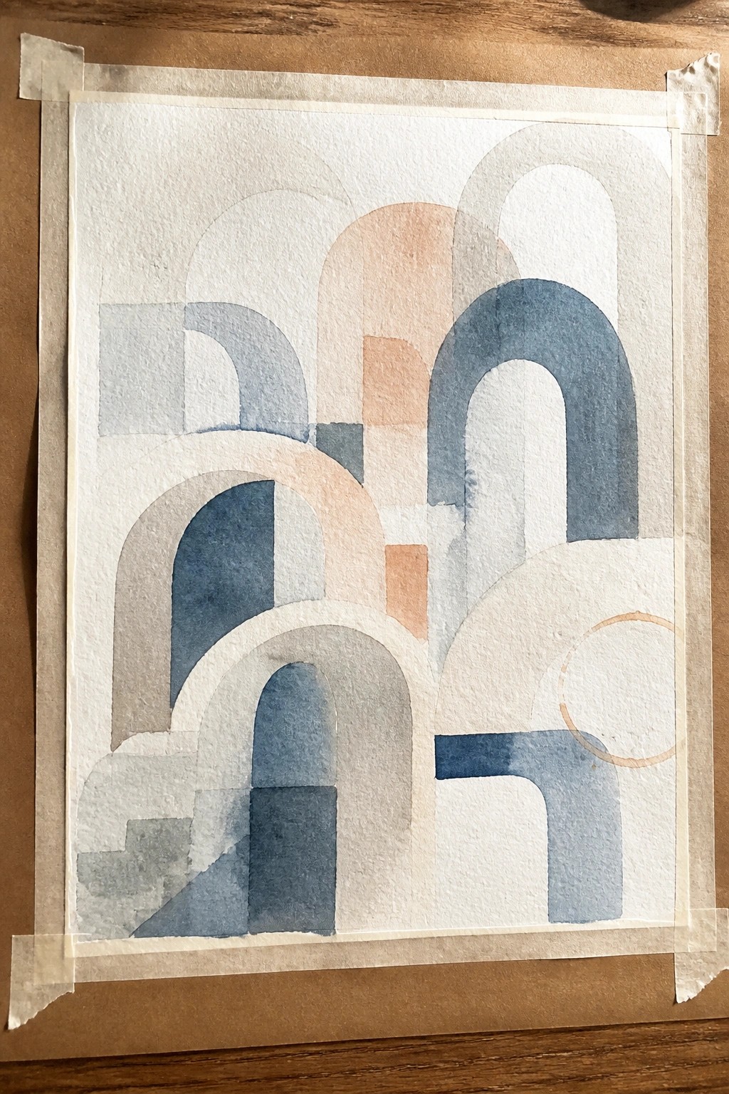 Abstract watercolor with overlapping arches in blue, peach, and neutral tones on paper