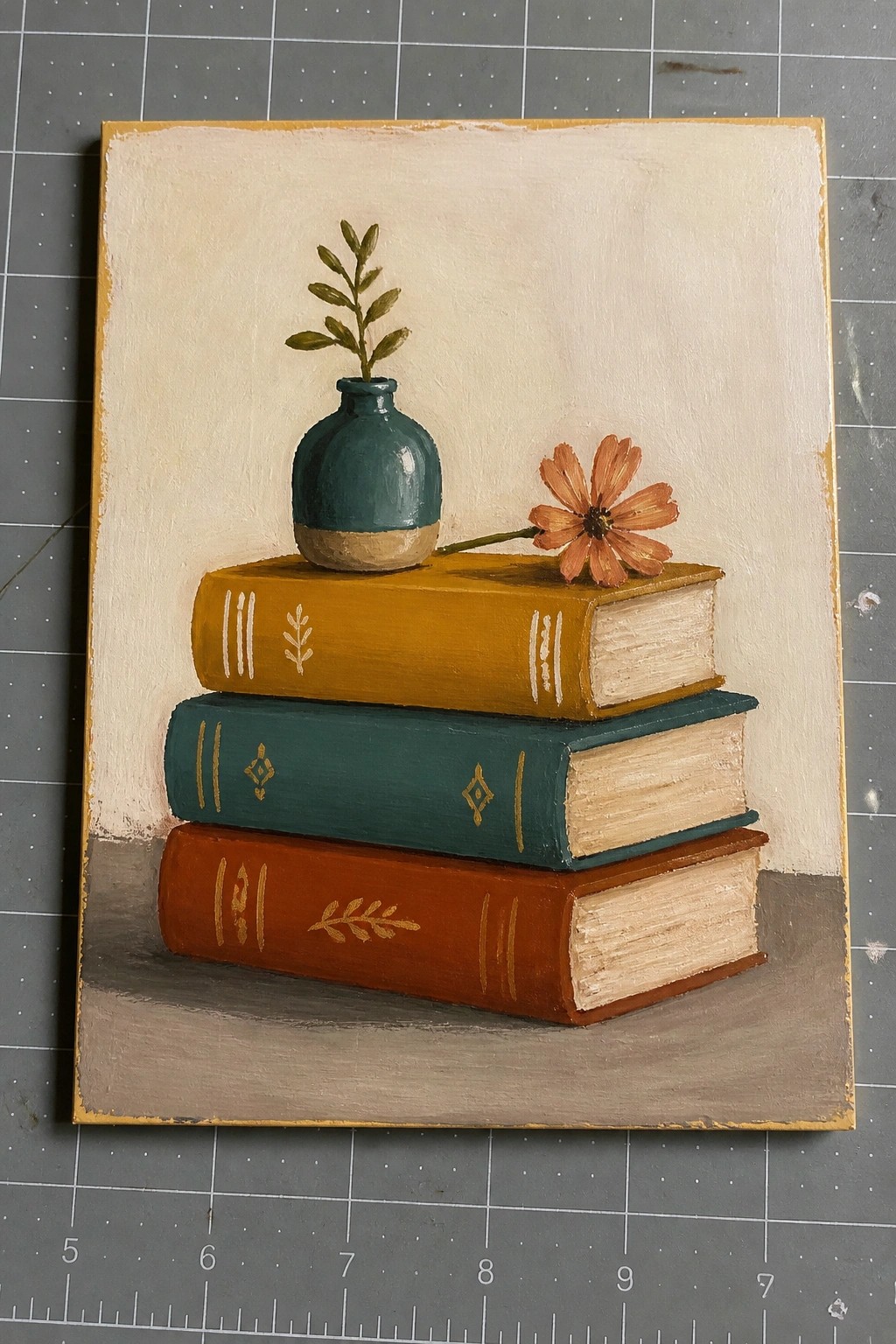 Still life painting of three stacked books with teal vase and orange flower
