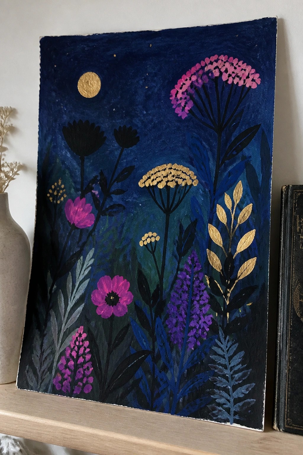 Nighttime floral painting with pink purple blooms, golden moon and leaf accents on deep blue.