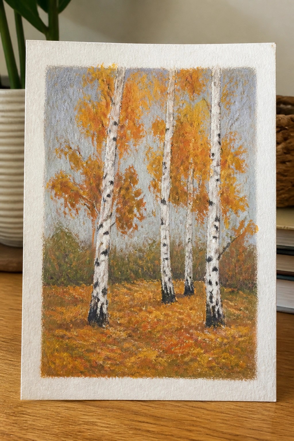 Pastel painting of white birch trees with orange autumn leaves on a forest floor