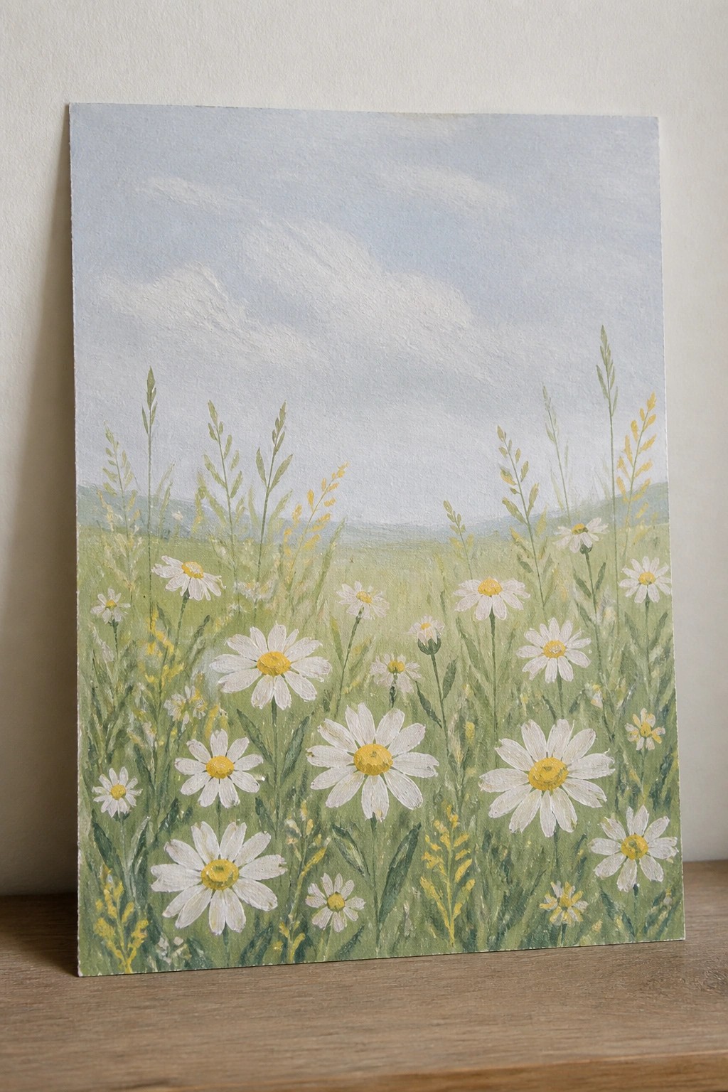 Canvas painting of white daisies blooming in green meadow under blue sky