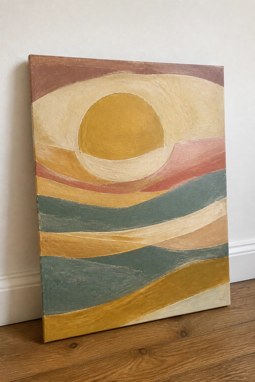 Abstract painting with yellow sun and wavy earth-toned stripes leaning against wall