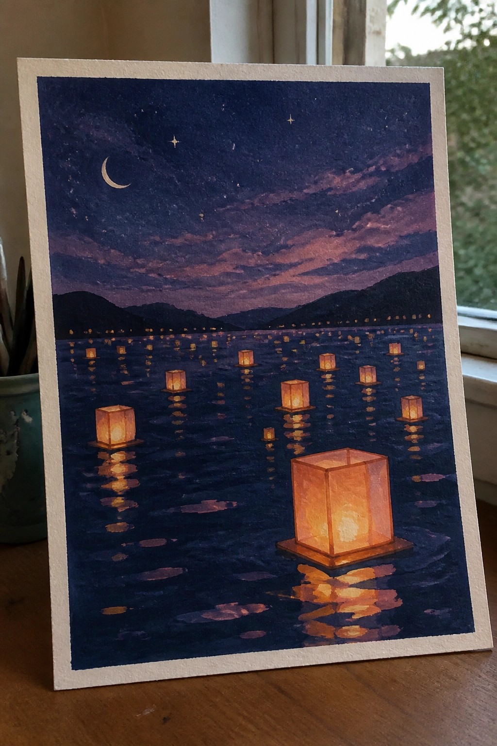 Watercolor of glowing lanterns floating on a dark lake under crescent moon and stars.