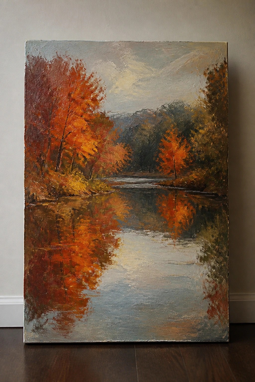 Oil painting of autumn trees with red-orange leaves reflecting in a calm river.