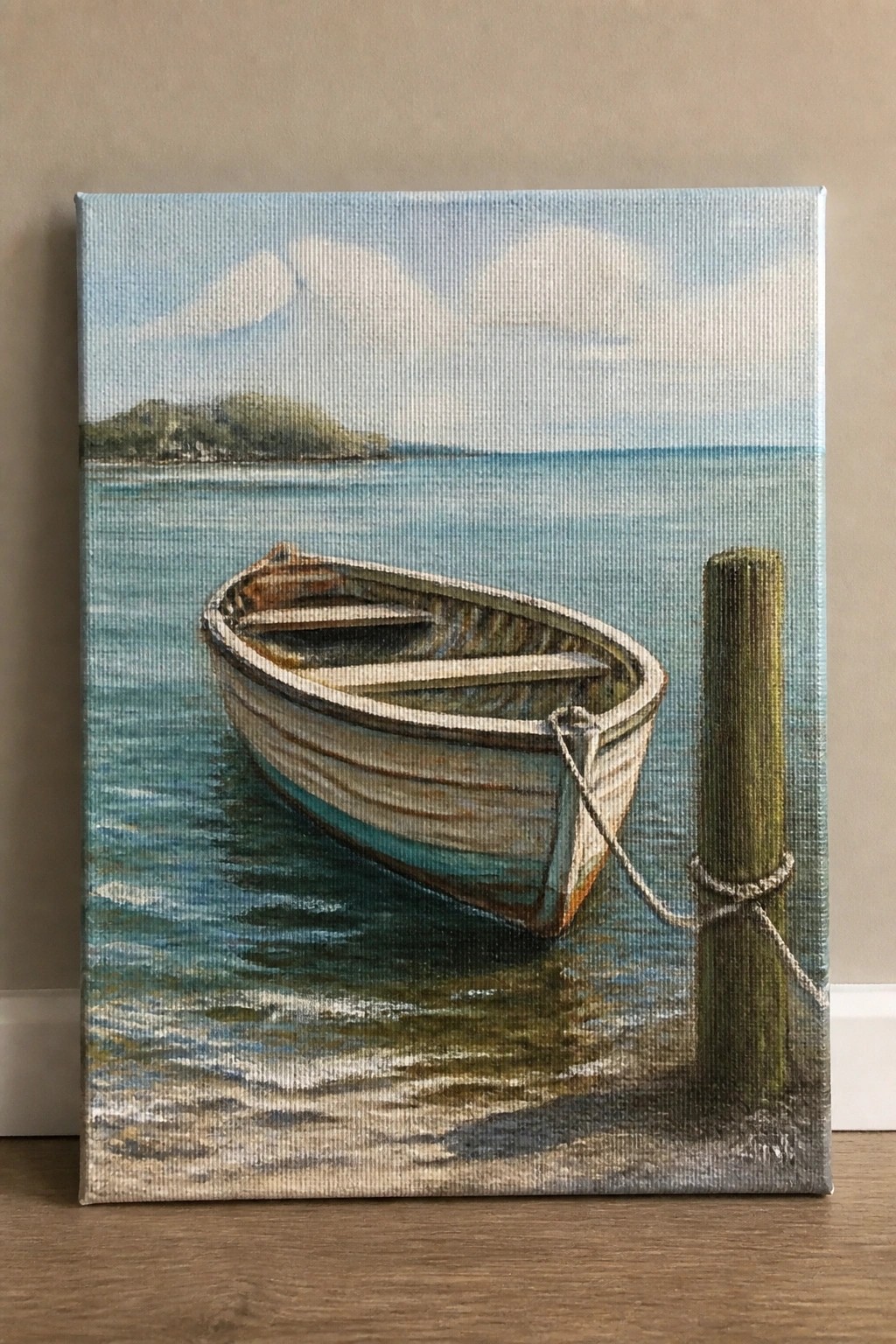 Realistic painting of white rowboat tied to wooden post in calm blue water with hills.