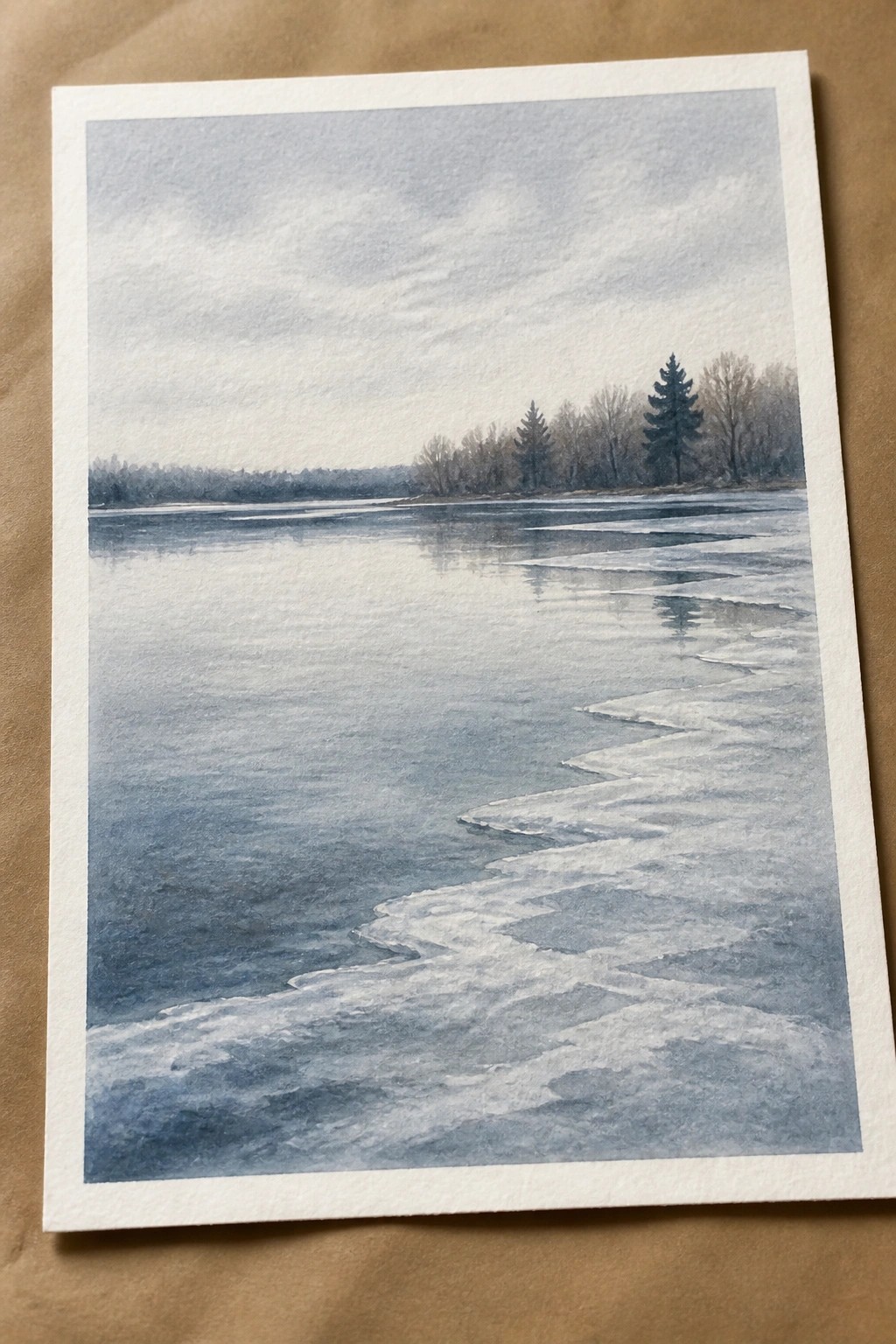 Watercolor of a partially frozen river with snow-dusted ice and distant bare trees