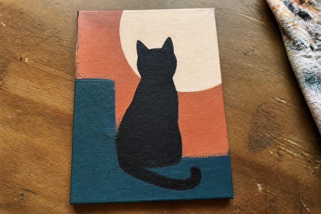 Black cat silhouette on canvas with orange, teal, and beige geometric shapes.