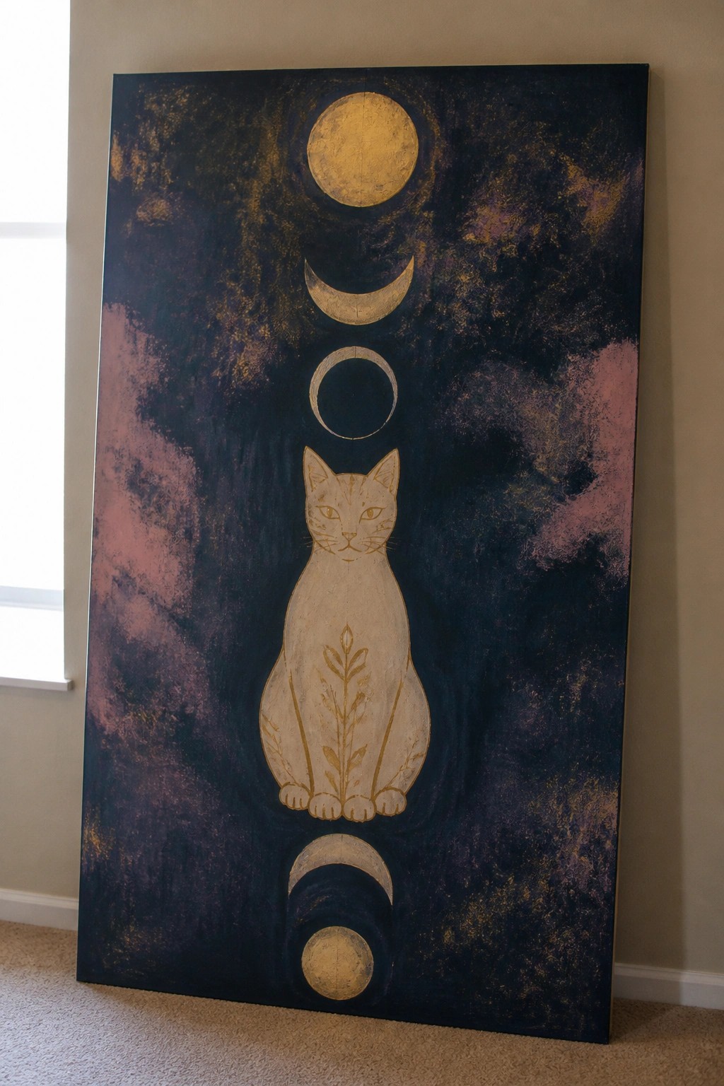 A tall acrylic painting shows a cat with gold outlines and moon phases above and below it on a dark textured background.