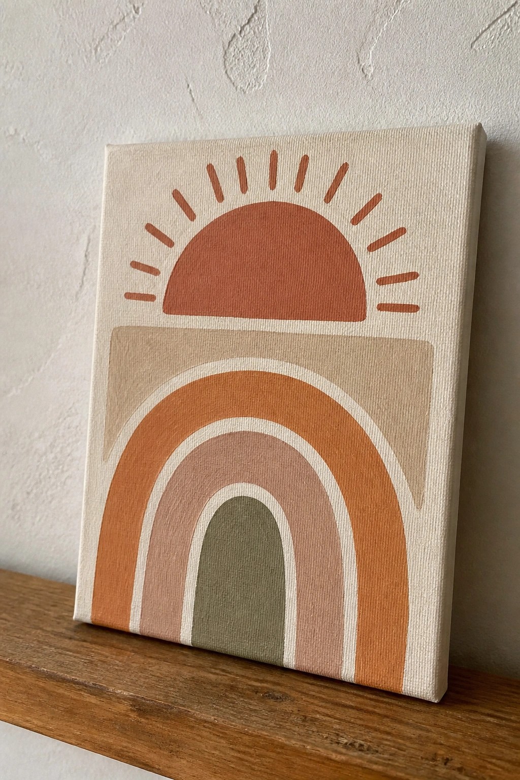 Boho canvas with terracotta sun rays above layered earth-tone rainbow arches.