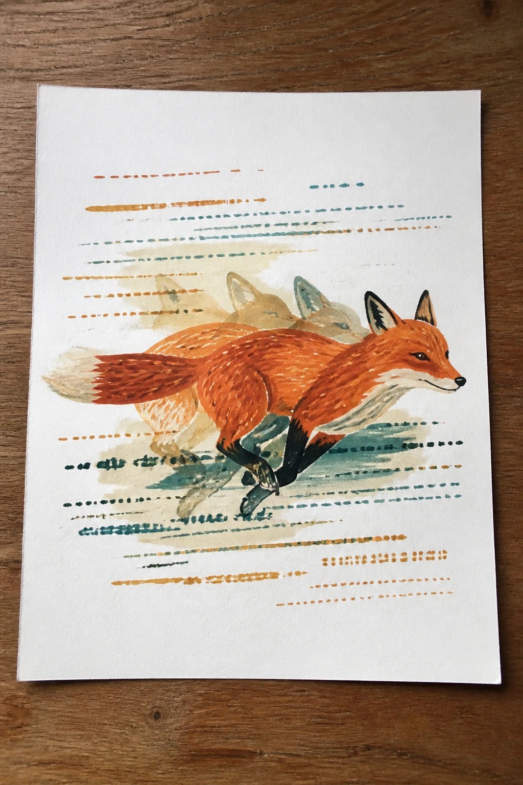 A watercolor painting of an orange fox running with faint overlapping fox figures behind it and colorful dashed lines on the paper.